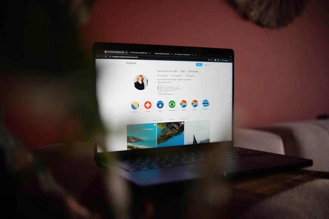 A close-up view of a smartphone screen displaying the email inbox, held by an adults hand.